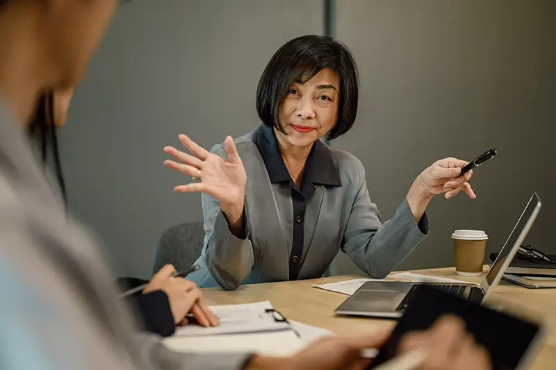 Middle-aged, Asian businesswoman in a negotiation meeting