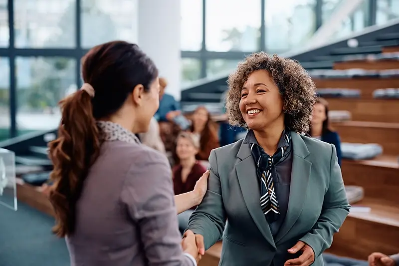 Business women talking at an event